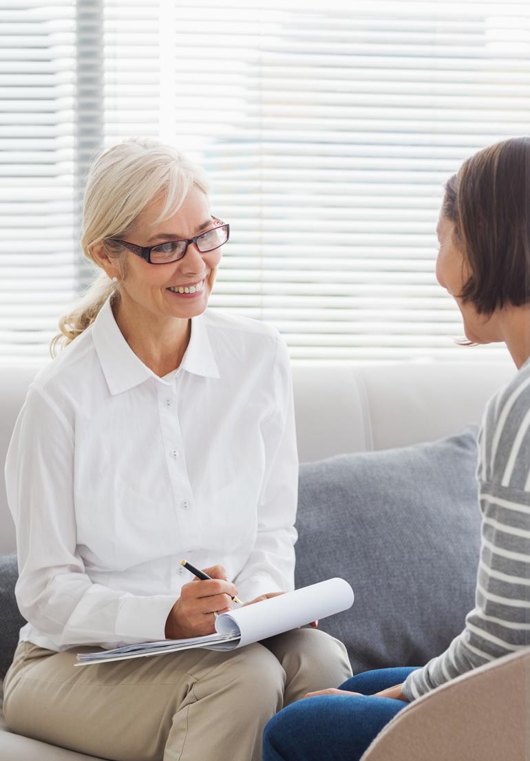 smiling therapist talking to her female client