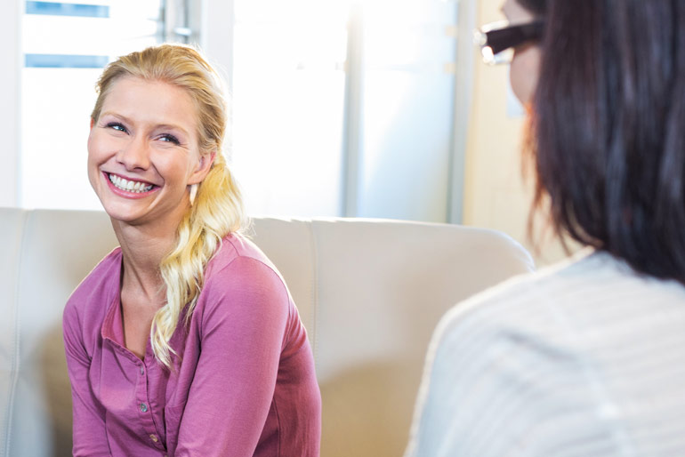 smiling blonde woman in therapy session
