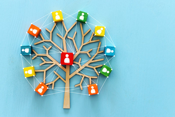 wooden colorful family tree on bright blue background - family addiction