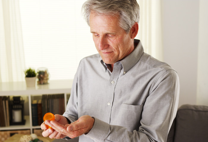 man in late sixties taking pills - older adults and substance use